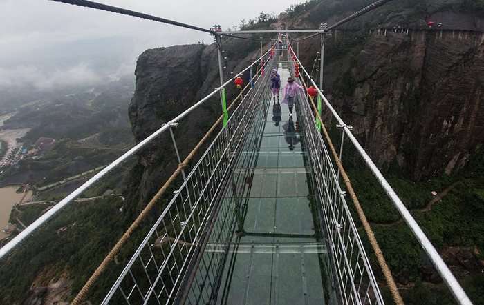 People crossing over the Brave Men’s Bridge with great difficulty