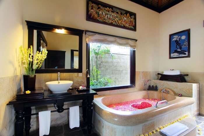 honeymoon suite's bathroom with bathtub in Furama Villas
