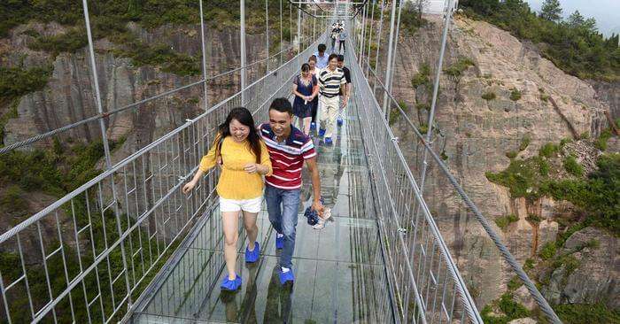 People enjoying the thrill of Haohan Qiao Bridge in China