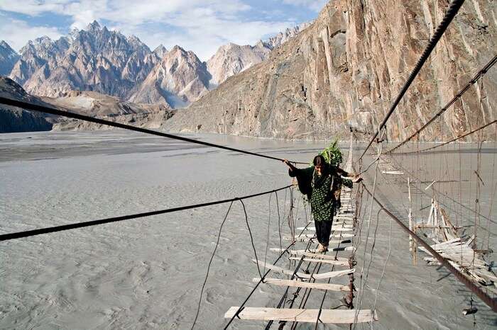 Women crossing over the dilapidated Hussaini Hanging Bridge in Northern Pakistan