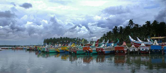 Several colorful boats stationed at Kozhikode Lake