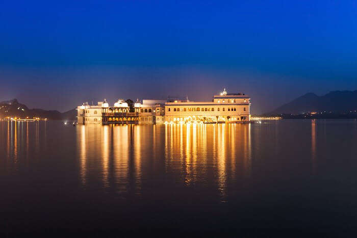 An illuminated Lake Palace is a popular tourist attraction in Rajasthan