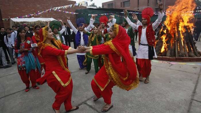 Men and women dancing during Lohri celebrations - the liveliest among winter festivals of India