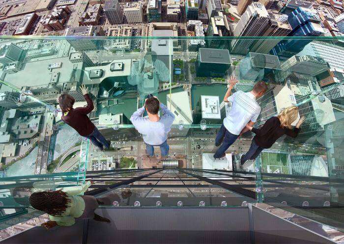 People looking out from Observation Deck at Willis Tower in Chicago