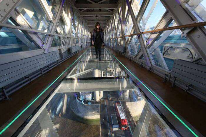 Girl walking over the Tower Bridge walkway in UK