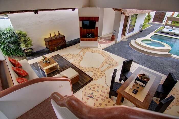 lounge area with television in villa seminyak