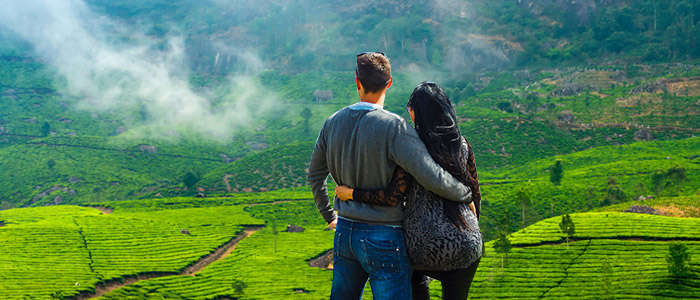 A couple enjoying the stunning green scapes of Munnar