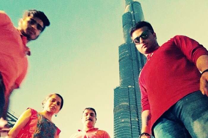 me and my family standing below burj khalifa