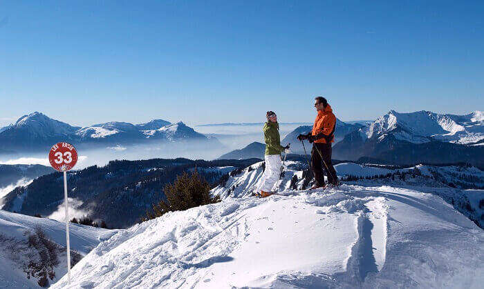 Two skiers take stance at the top of a slope at Morzine ski resort