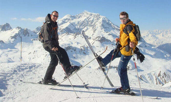 Skiers pose at the top of a slope at Tignes ski resort