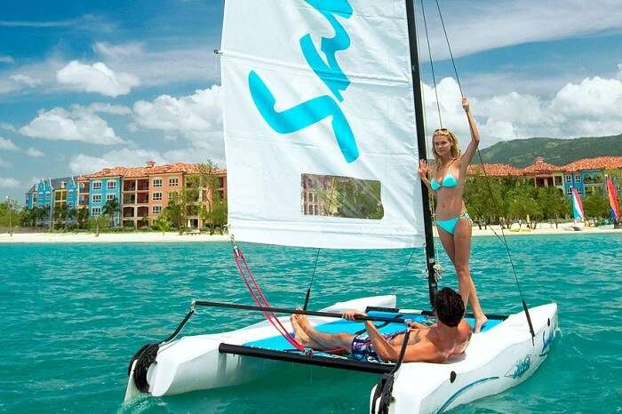 kw-030617-A couple riding a Hobie Cat near a resort on their Caribbean honeymoon