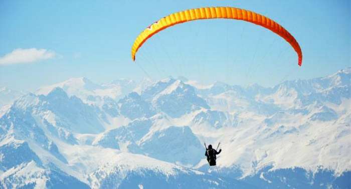 Paragliding over the snow-capped mountains of himalayas