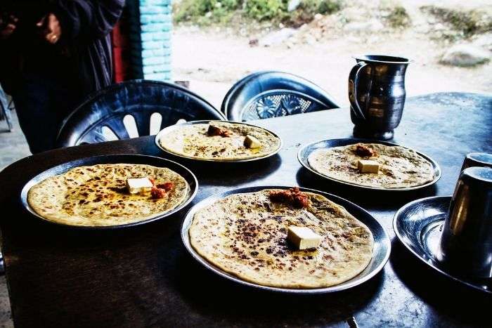Butter rich stuffed kulchas served with pickle at Deepak Dhaba in Dhanaula