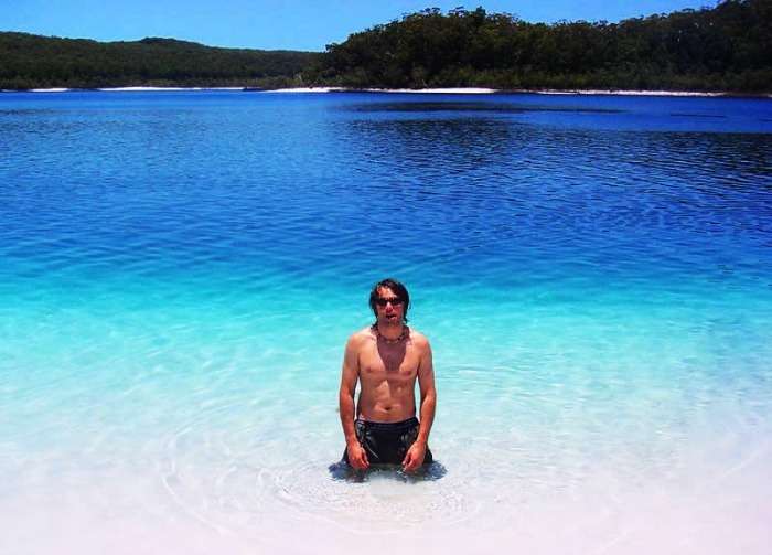 A man swimming in the waters of the hovering Lake McKenzie