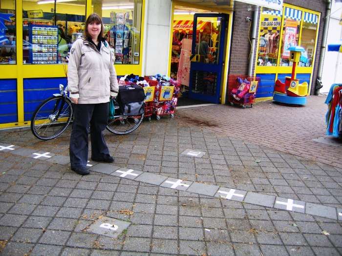 A woman stands on the International Border of Netherlands & Belgium
