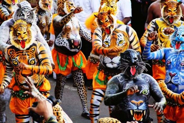 Performers dancing during Puli Kali in Thrissur