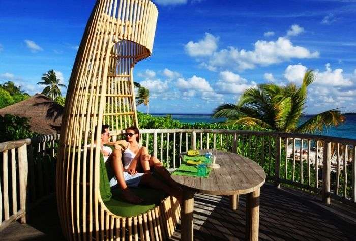 A couple relaxing at the Six Senses Laamu
