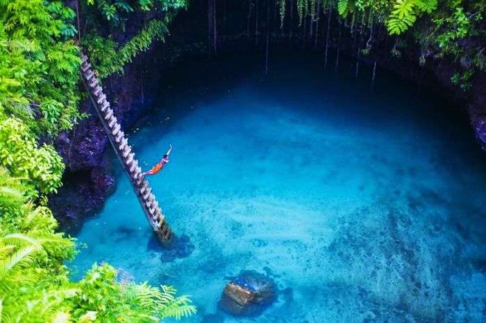 A Swimmer Diving Into To Sua Ocean Trench