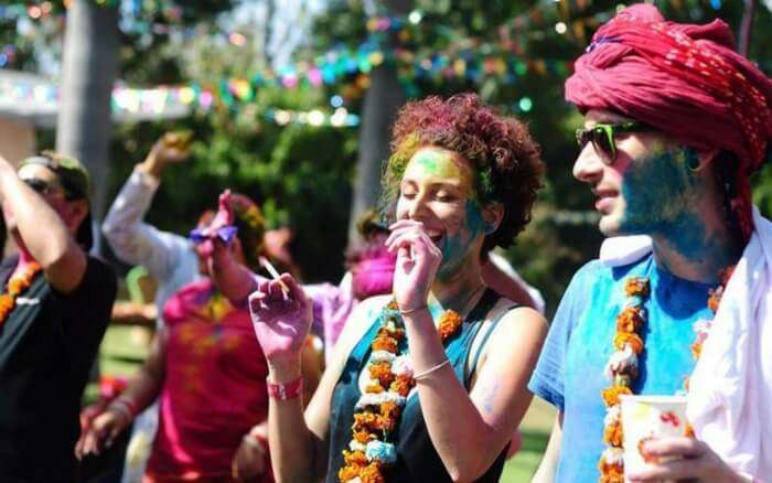 People playing with colors during Holi Cow festival in Delhi