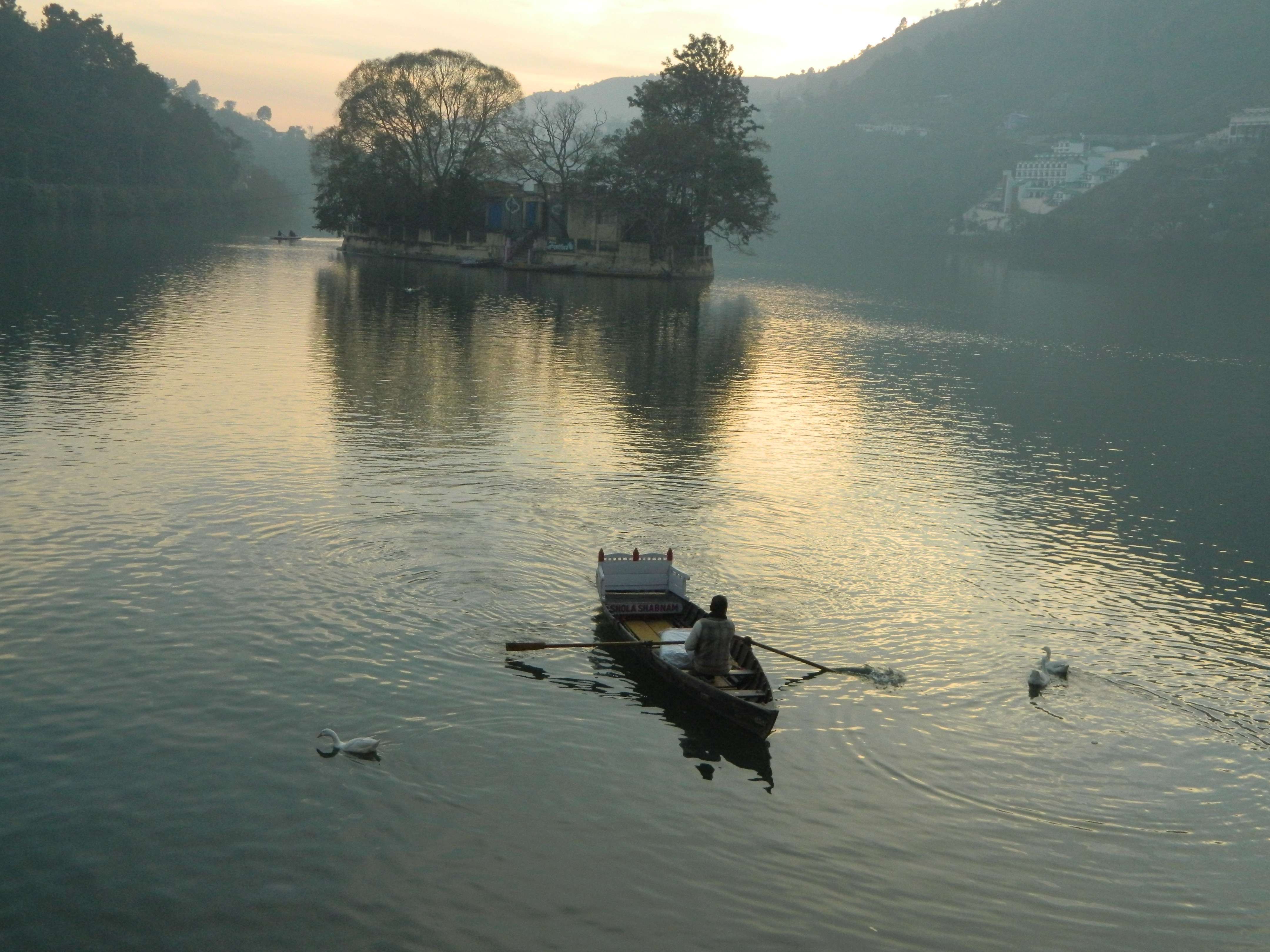 a man rowing boat in a lake