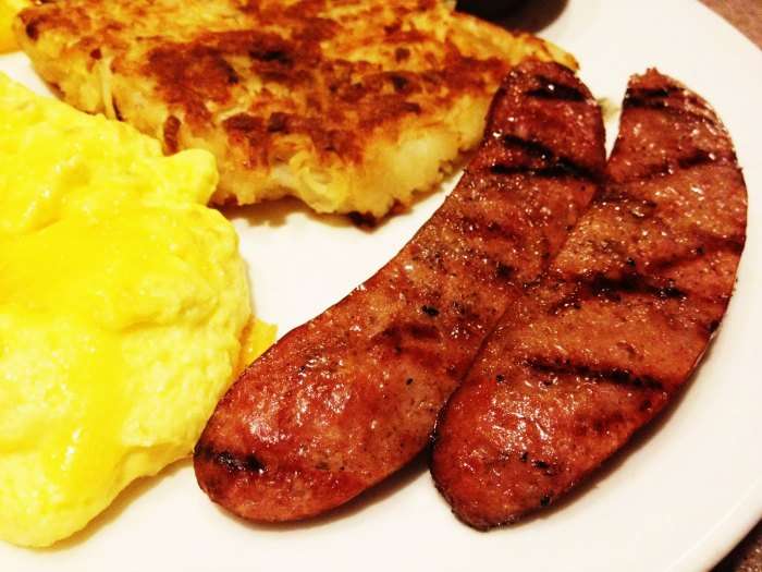 Scrumptious Alaska breakfast made up of pancakes, eggs and reindeer meat pieces.