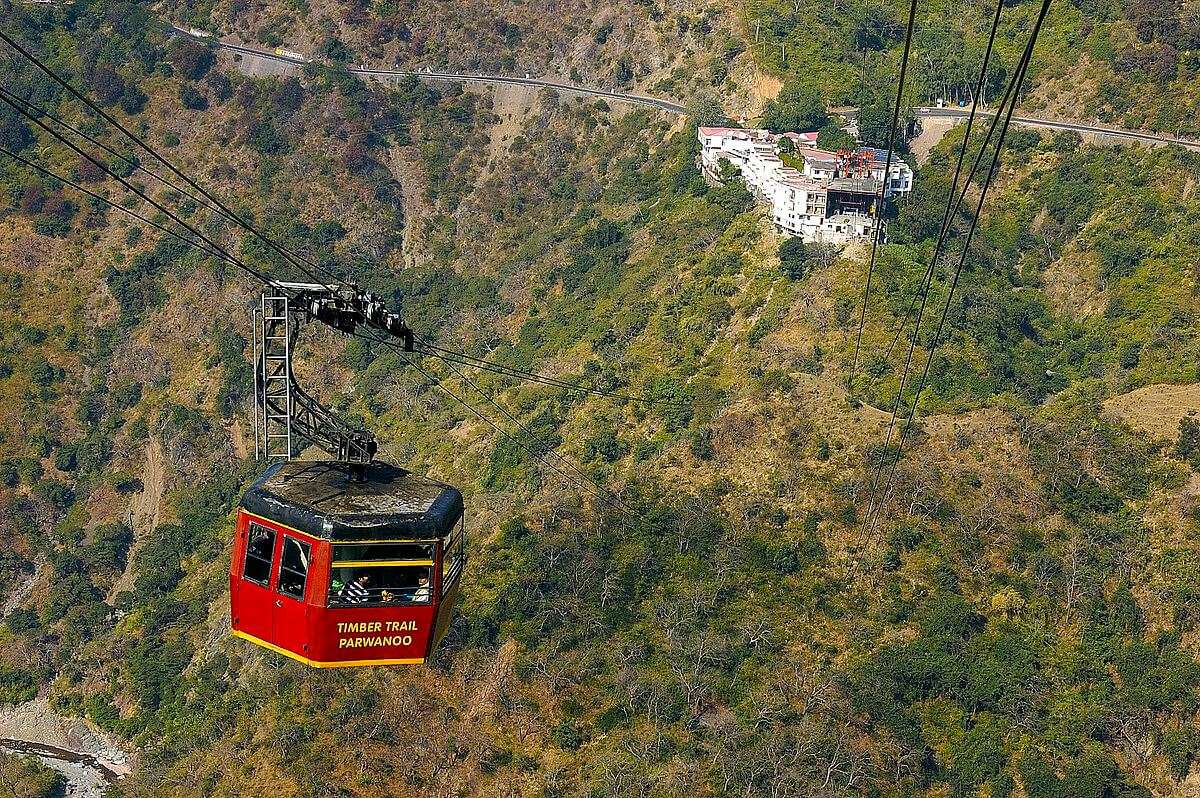 a red colour cable car in mountains