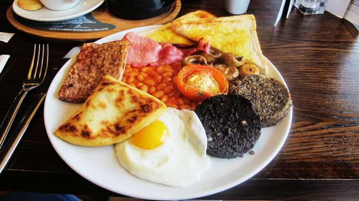 The delicious Scottish breakfast is laden with fried eggs along with back bacon, black pudding and buttered toast.