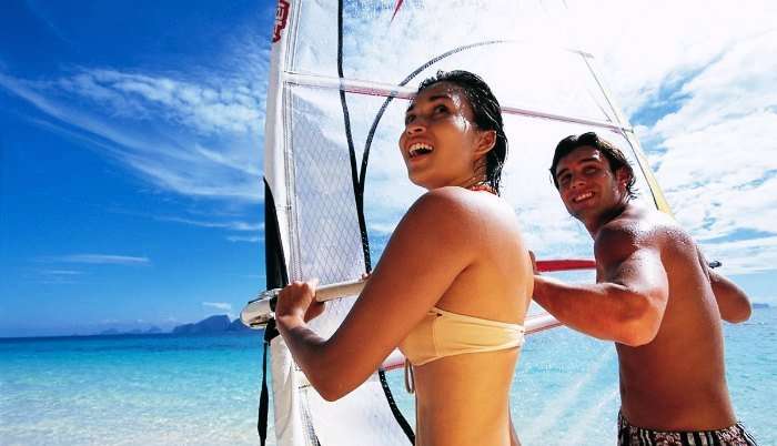 A couple windsurfing in Seychelles