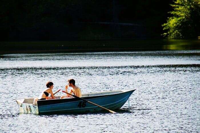 A couple rowing a boat