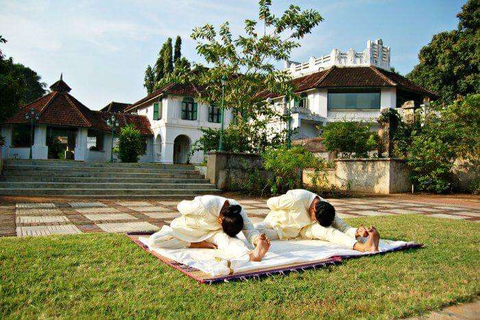 People practising yoga at one of the best yoga and meditation retreats in India - Kalari Koavilakom