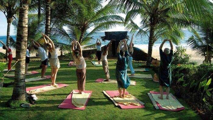 People practicing yoga at Sivananda Yoga Vedanta Dhanwantari Ashram in Kerala