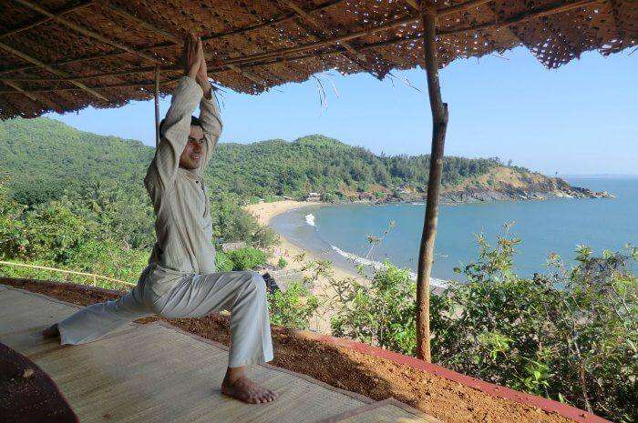 A man performing surya namaskar at SwaSwara Yoga center in Gokarna