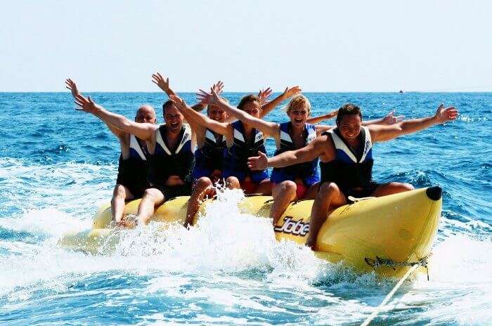 Friends enjoying the banana tube boat ride in Goa