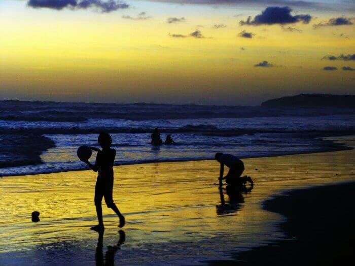 People playing at Ganpatipule beach in Maharashtra