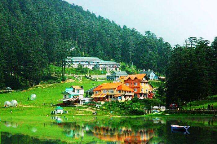 A serene view of the lake in Khajjar with Zorbing taking place in distant background