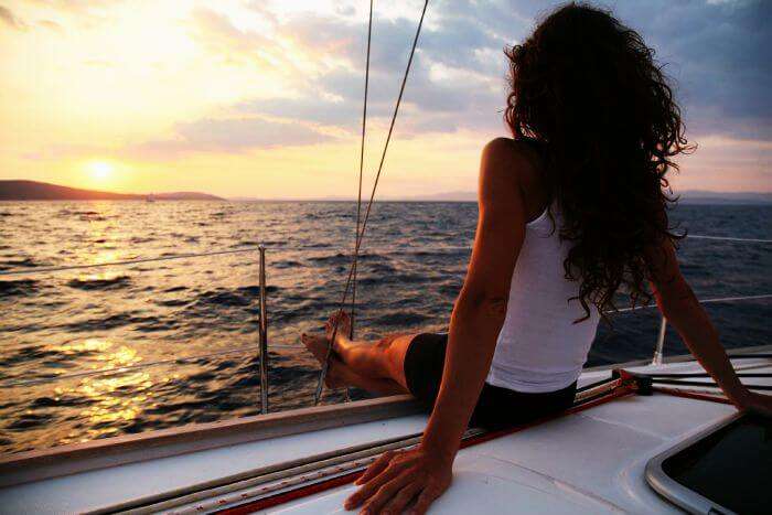 Sail through the ocean during sunset