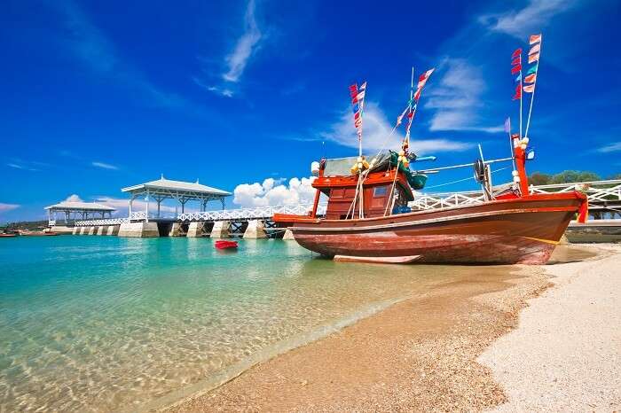 Fishing boat and wood waterfront pavilion at Koh si chang island in Thailand