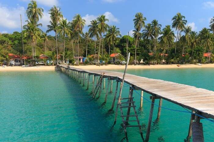 Wooden pontoon in the turquoise tropical sea of Ao Phrao beach in Koh Kut island