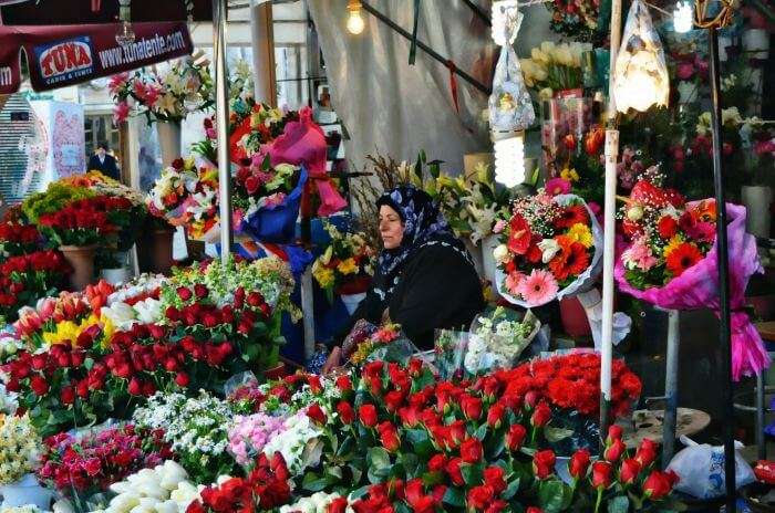 A lady on the stands of Cicek Pazari selling flowers