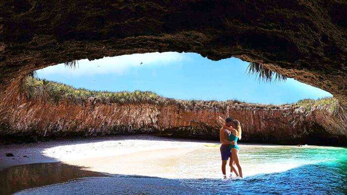 A couple enjoying the beauty and privacy at Mexico’s famous hidden cave beach