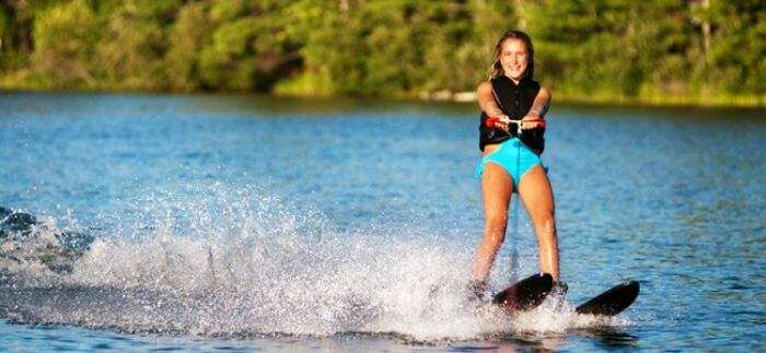 A girl enjoying water skiing on the blue waters of Bali