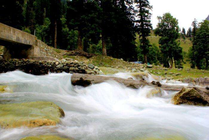 Water flows under a bridge in the valley of Kashmir