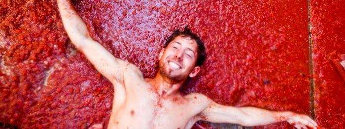A man enjoys the tomato slush at the La Tomatina festival in Spain