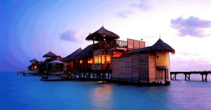 A beautiful view of a water villa during the evening hours in Bali