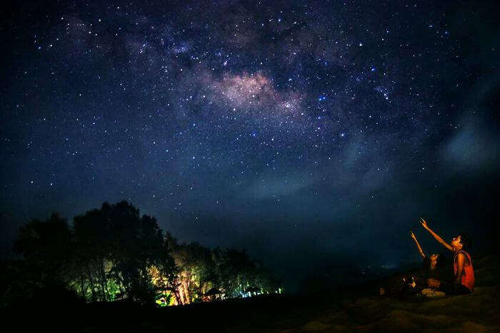 Two children enjoy the breathtaking experience of stargazing at Tarkarli