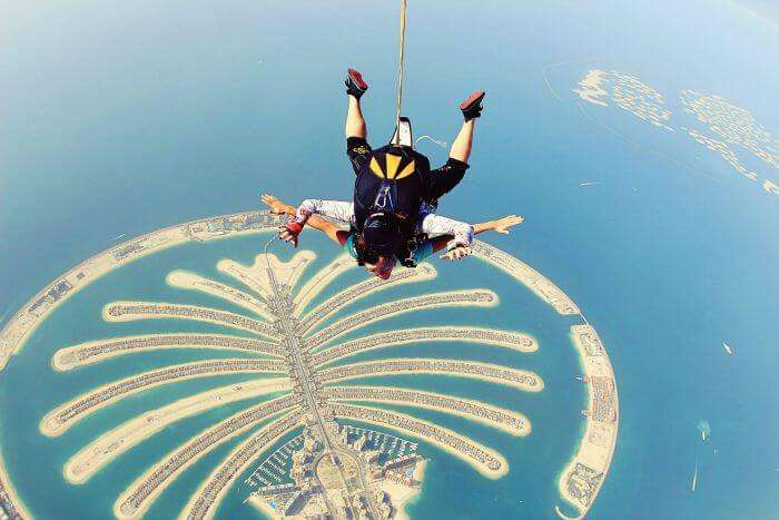 A couple hang-gliding above the world’s only man-made island in the shape of a tree – Dubai Palm Islands