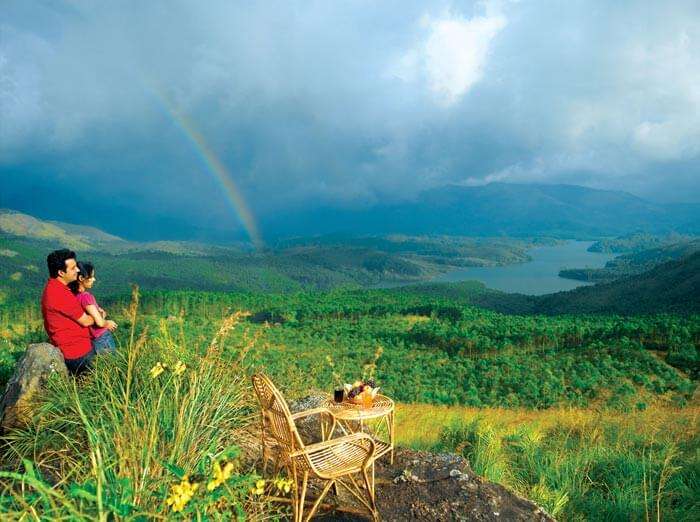 A couple watches over the scenery of Ooty, one of the popular budget honeymoon destinations in India