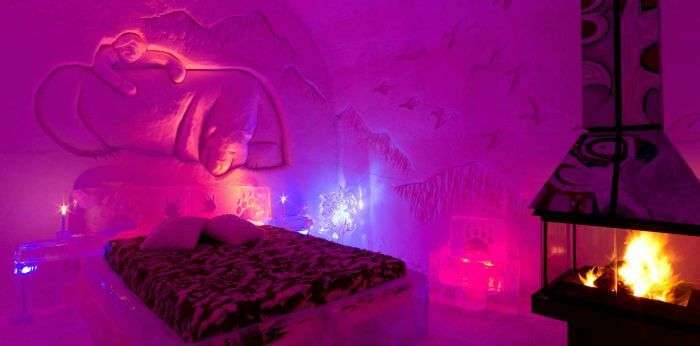 The ice structure rooms illuminated with colorful lights in Hotel De Glace at Canada