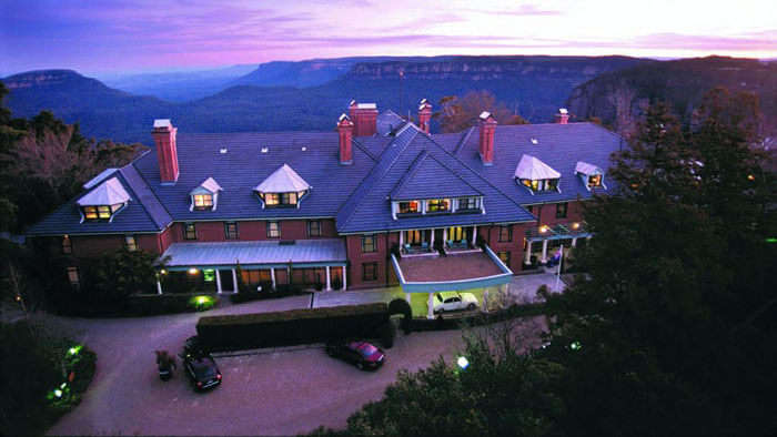 The Lilianfels Blue Mountains Resort and Spa against a background of the blue hills