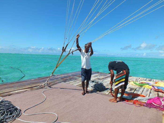 Two men getting ready for platform parasailing
